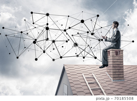 Man on roof with smartphone and concept of social connection 70185508