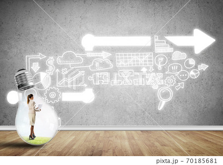Businesswoman trapped in bulb Businesswoman trapped in bulb 70185681