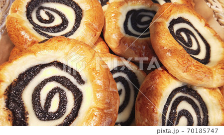 Sour cream buns swirl with poppy seeds closeup background. Sweet pastry. Apetite buns. Smetannik cookies famous in Russian . 70185747