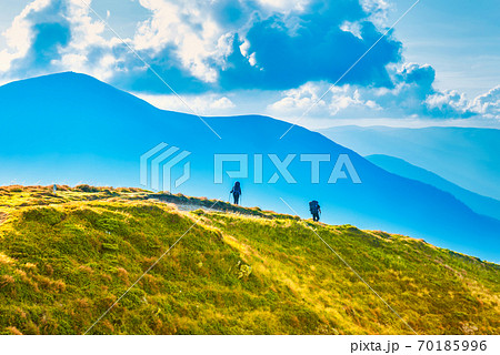 People travelling in mountains 70185996