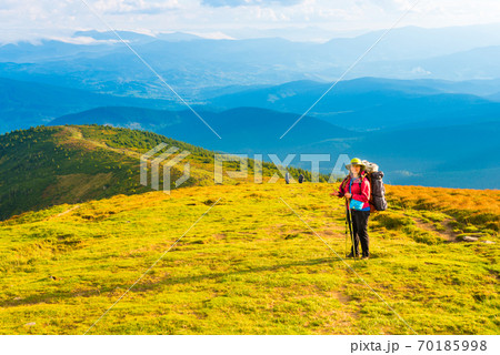 Woman looking at mountain landscape Woman looking at mountain landscape 70185998