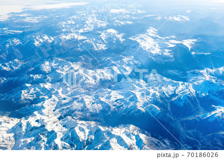Airplane view of mountains covered with snow Airplane view of mountains covered with snow 70186026