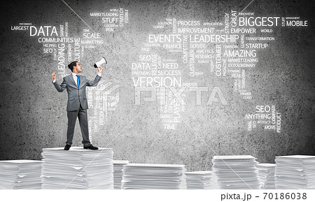Businessman standing with megaphone. 70186038