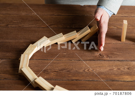 Business woman block domino effect. Business woman block domino effect. 70187806