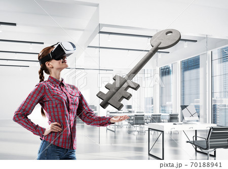 Girl in virtual reality mask experiencing virtual technology world. Mixed media 70188941