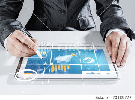 Media technologies for business as concept with woman working on tablet Media technologies for business as concept with woman working on tablet 70189722