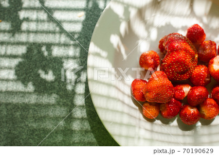 Delicious strawberry in a plate in sunlight. Delicious strawberry in a plate in sunlight. 70190629