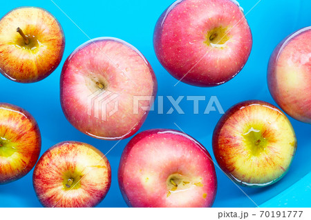 Washing fresh apples in the water 70191777
