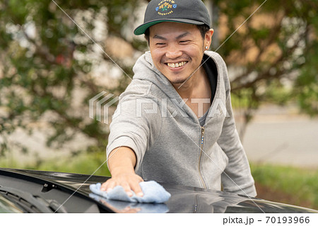 笑顔で洗車する男性 70193966