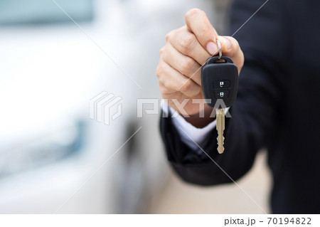 Car key, businessman handing exchange over give to the other man on showroom 70194822