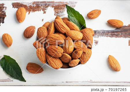 Peeled almonds on a wooden rustic background. Copy space. 70197265