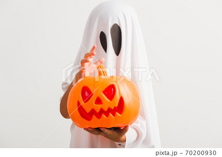 child with white dressed costume halloween ghost scary he holding orange pumpkin ghost on hand child with white dressed costume halloween ghost scary he holding orange pumpkin ghost on hand 70200930