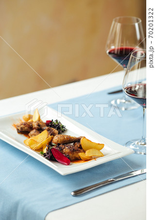 Closeup on grilled chicken with potatoes and wine Closeup on grilled chicken with potatoes and wine 70201322