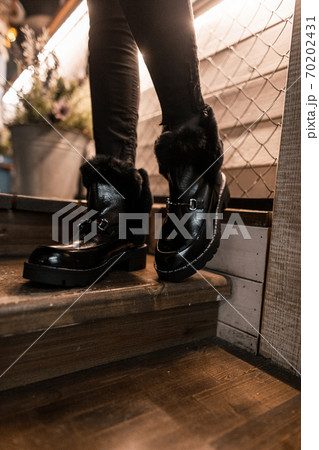 Beautiful fashionable black warm boots close-up. 70202431