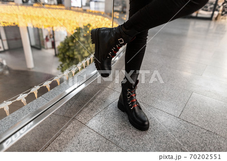 Urban young woman in a vintage black leather boots Urban young woman in a vintage black leather boots 70202551