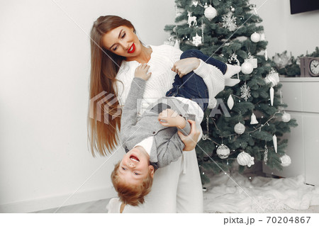 Mother with son in a Christmass decorations Mother with son in a Christmass decorations 70204867