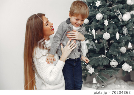 Mother with son in a Christmass decorations Mother with son in a Christmass decorations 70204868