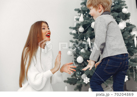 Mother with son in a Christmass decorations Mother with son in a Christmass decorations 70204869