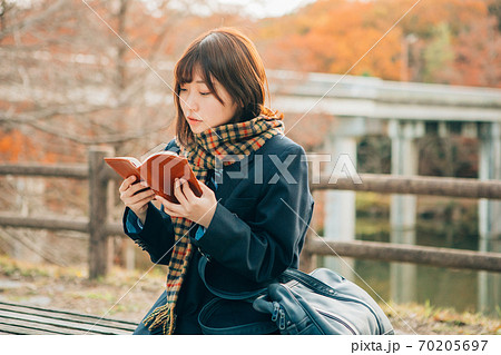 冬の屋外で読書をする高校生 70205697