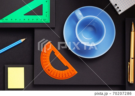 office supplies and empty cup of coffee at black background office supplies and empty cup of coffee at black background 70207286