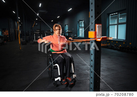 Disabled woman training in the gym of rehabilitation center Disabled woman training in the gym of rehabilitation center 70208780