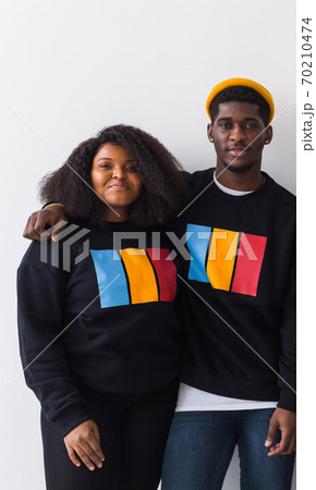 Happy African American woman and man have relationships, toothy smile, happy to meet with friends, dressed casually on white background. Emotions and friendship concept. 70210474