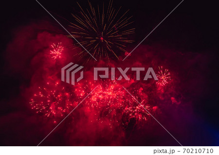 Beautiful colorful holiday fireworks in the evening sky with majestic clouds Beautiful colorful holiday fireworks in the evening sky with majestic clouds 70210710