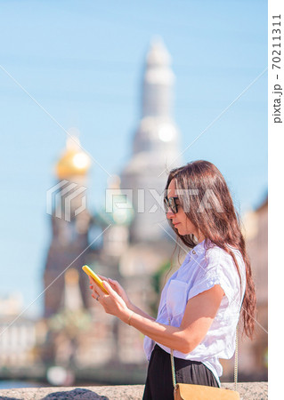 Woman at the summer waterfront in Saint Petersburg outdoors Woman at the summer waterfront in Saint Petersburg outdoors 70211311