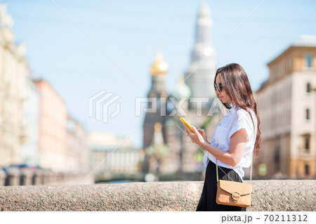 Woman at the summer waterfront in Saint Petersburg outdoors Woman at the summer waterfront in Saint Petersburg outdoors 70211312