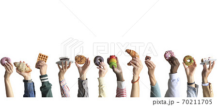 People are holding different desserts in their hands. The concept of food and sweets. People are holding different desserts in their hands. The concept of food and sweets. 70211705