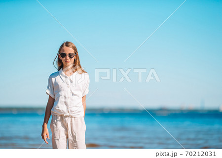 Young beautiful girl having fun on tropical seashore. 70212031