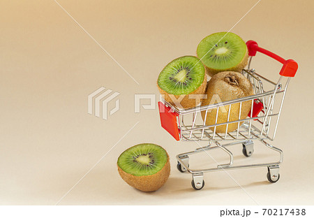 Fresh ripe kiwi in supermarket cart. Space for text 70217438
