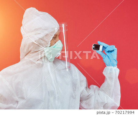 female doctor in a chemical suit. concept of medicine. red background 70217994