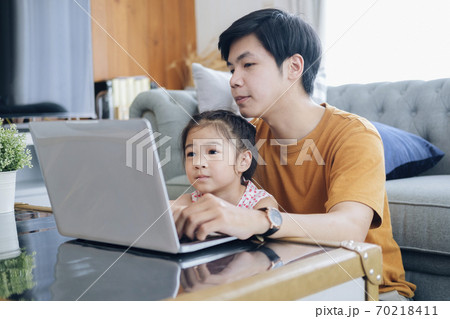 Young man and school-girl working form home and e-learning. Young man and school-girl working form home and e-learning. 70218411