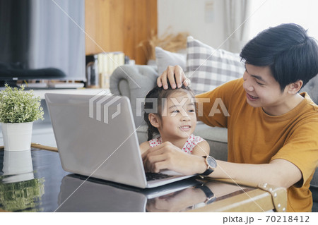 Young man and school-girl working form home and e-learning. 70218412