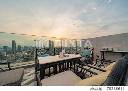 Sky bar, a restaurant or cafe lounge terrace with dinner table on rooftop of hotel, high rise architecture building with city view in Bangkok downtown skyline, urban city, Thailand. 70218611