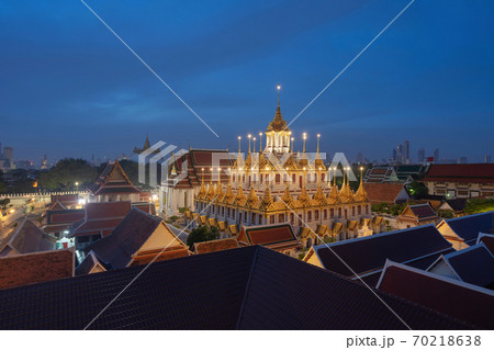 Loha Prasat Wat Ratchanatda and Golden Mountain pagoda, a buddhist temple or Wat Saket with skyscraper buildings in Bangkok Downtown, urban city, Thailand. Thai Landmark. Architecture at night. Loha Prasat Wat Ratchanatda and Golden Mountain pagoda, a buddhist temple or Wat Saket with skyscraper buildings in Bangkok Downtown, urban city, Thailand. Thai Landmark. Architecture at night. 70218638
