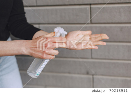 Woman holding antiseptic in her hands Woman holding antiseptic in her hands 70218911