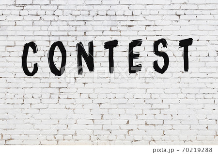 Inscription contest painted on white brick wall 70219288