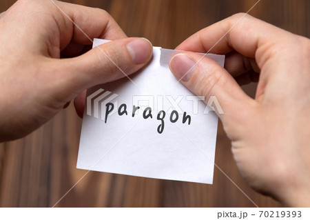 Hands tearing off paper with inscription paragon Hands tearing off paper with inscription paragon 70219393