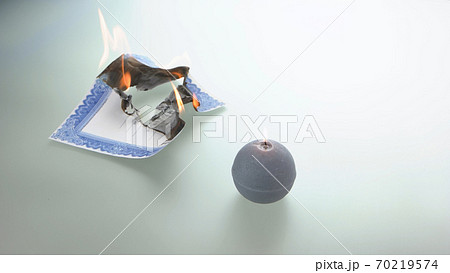 Round candle and burning stock certificate. Round candle and burning stock certificate. 70219574