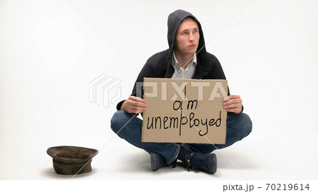 Man begs with I am unemployed cardboard sign. 70219614