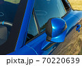 close-up of the rearview mirror of a blue sports car 70220639
