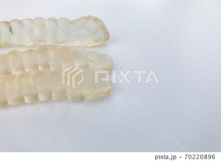 gummy worms lie on a white matte background 70220896