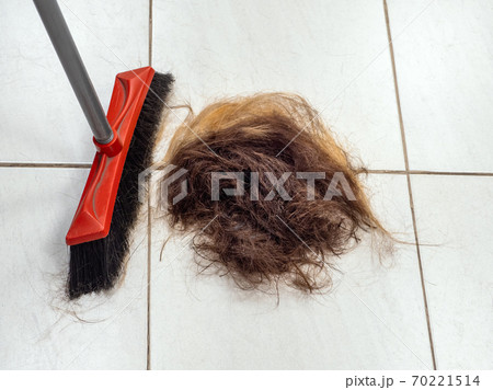 A pile of cut hair on the barber shop floor  70221514