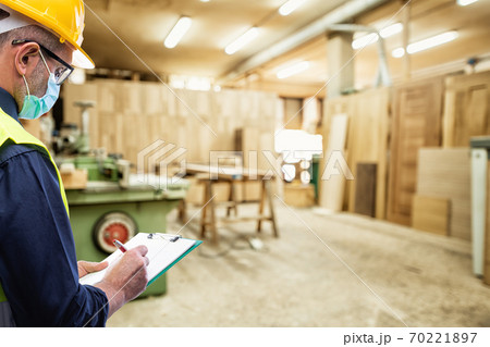 Engineer at work protects the face with the surgical mask. Construction industry. Covid-19 prevention. 70221897