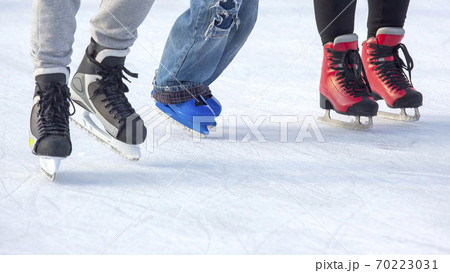 people ice skating on an ice rink. Hobbies and sports. Vacations and winter activities. 70223031