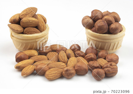 Different nuts in a waffle basket on a white background. Vitamin wholesome food. 70223096