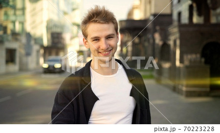 Smiling guy in casual clothes at summer day near the road 70223228