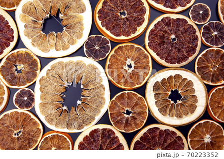 Dried of various citrus fruits closeup on dark background Dried of various citrus fruits closeup on dark background 70223352